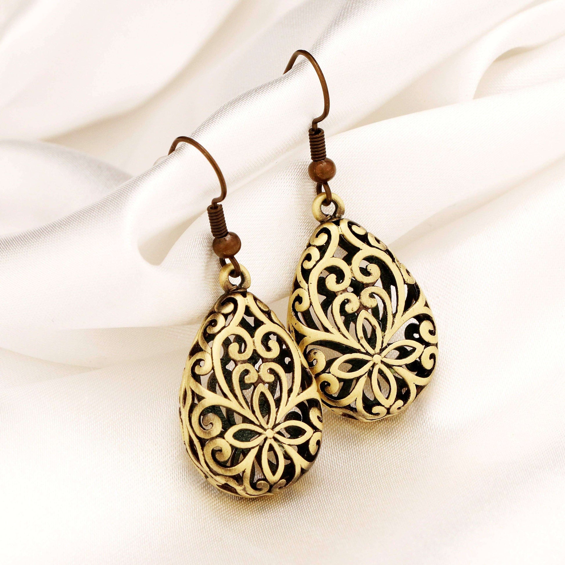 Vrouw draagt vintage brons oorringen MARRAKESH met sierlijke openwork patronen